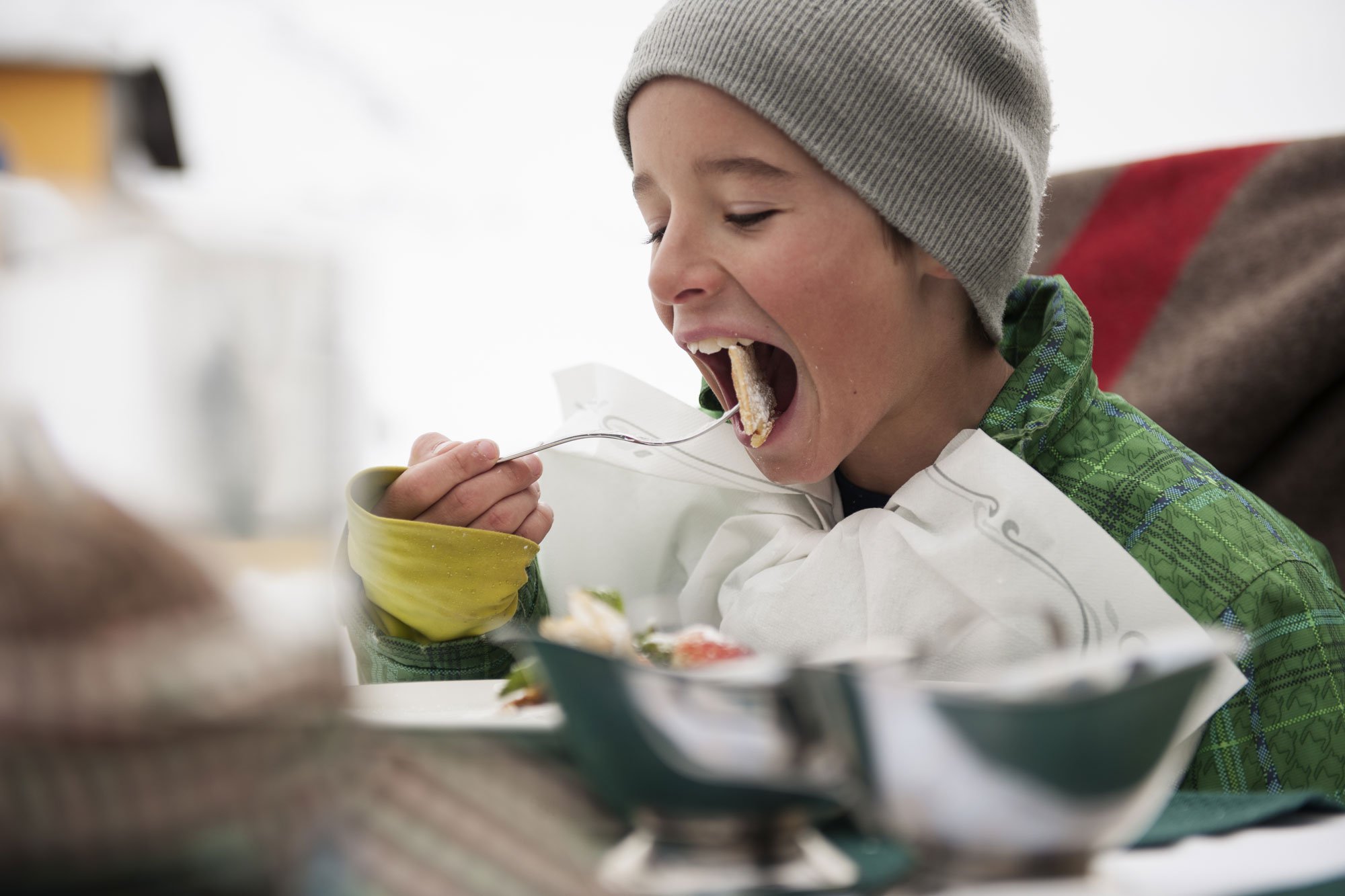 Skiing makes hungry. A young winter sportsmen enjoys his 